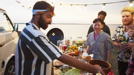 Positive-Food-Truck-Seller-Giving-Hot-Dog-to-Asian-Woman-on-Summer-Festival