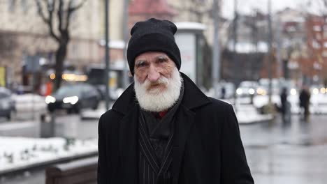 portrait of an elderly man in a city street
