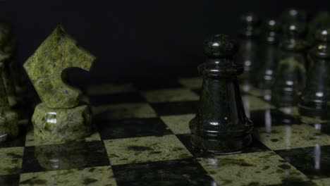 close-up of a chess game with unique green stone pieces