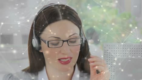 Animation-of-networks-of-connections-over-businesswoman-wearing-phone-headset