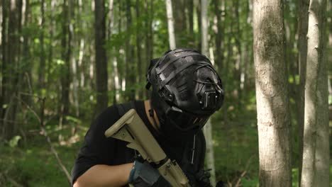 slow motion tactical guy in forest looking around