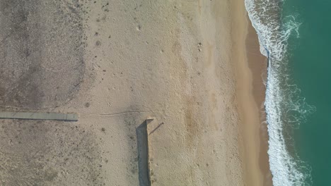 Aerial-view-of-the-beach-without-people-with-drone-turquoise-water-sand-Wooden-walkway