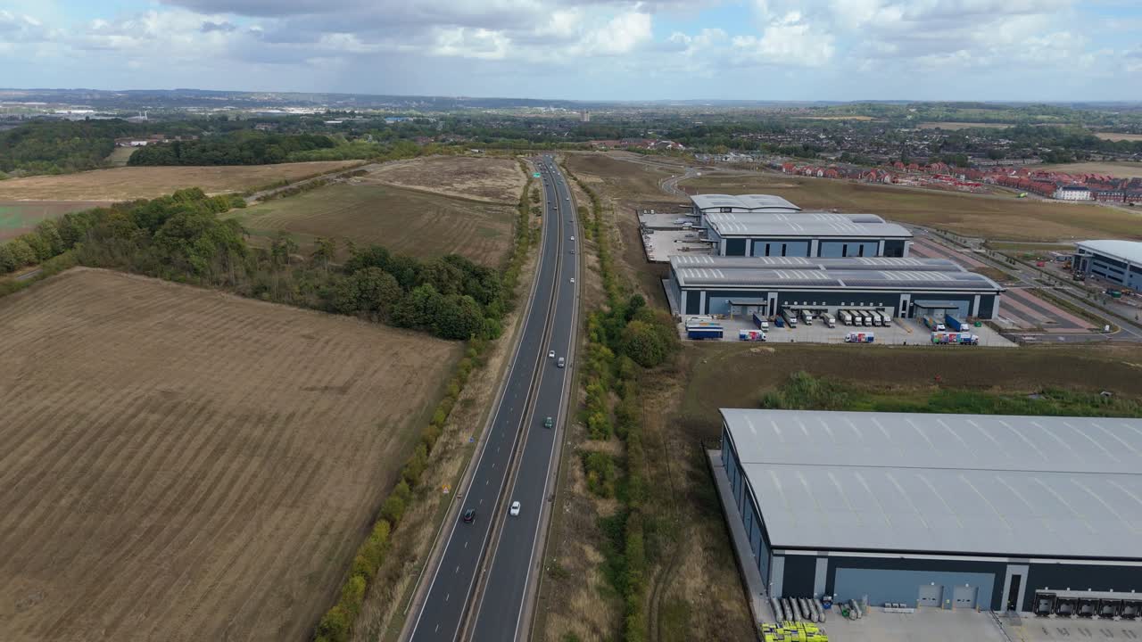 Drone orbit of manufacturing and warehouse facilities near motorway and green fields in Nottinghamshire