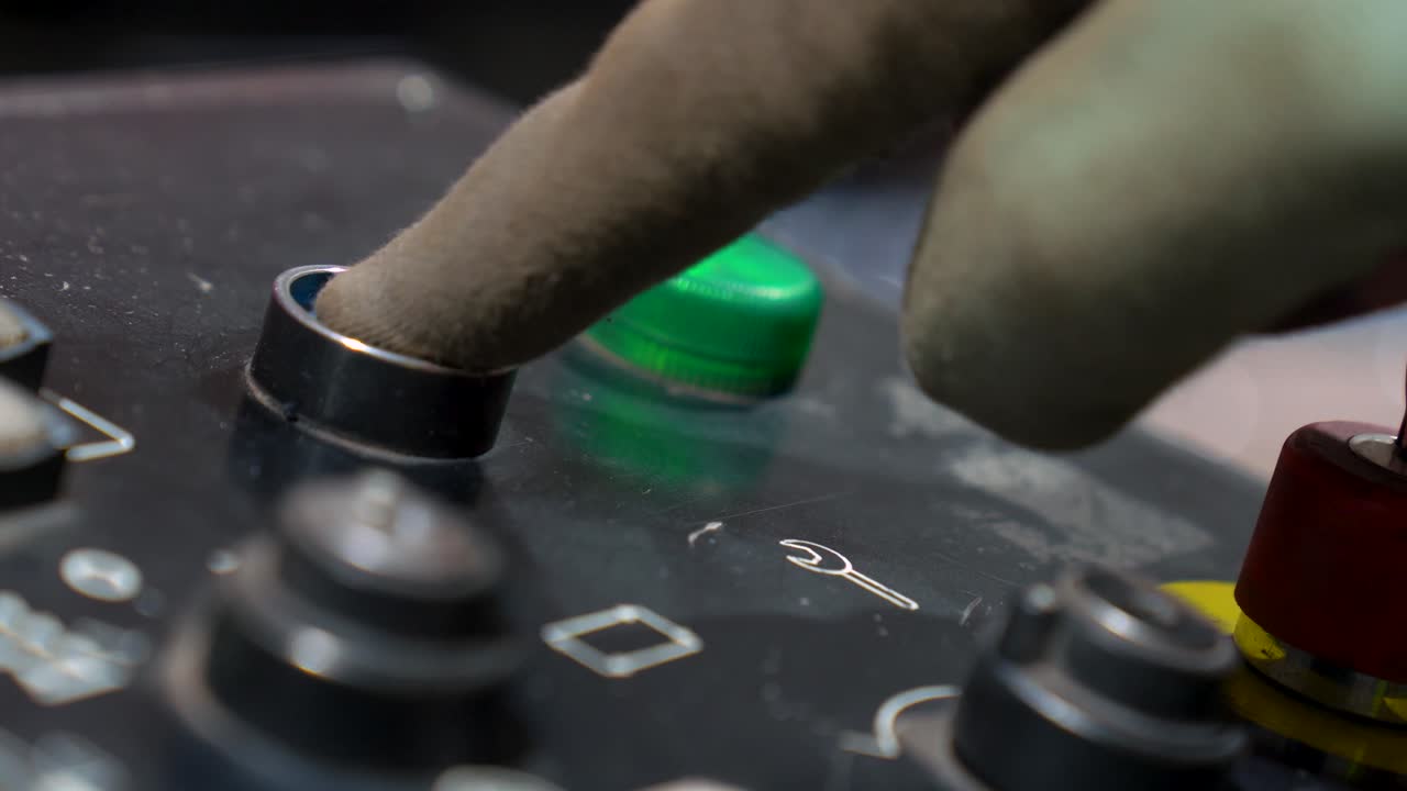 CNC Machine Operator Pressing Buttons On The Control Panel During Manufacturing, Close Up Shot