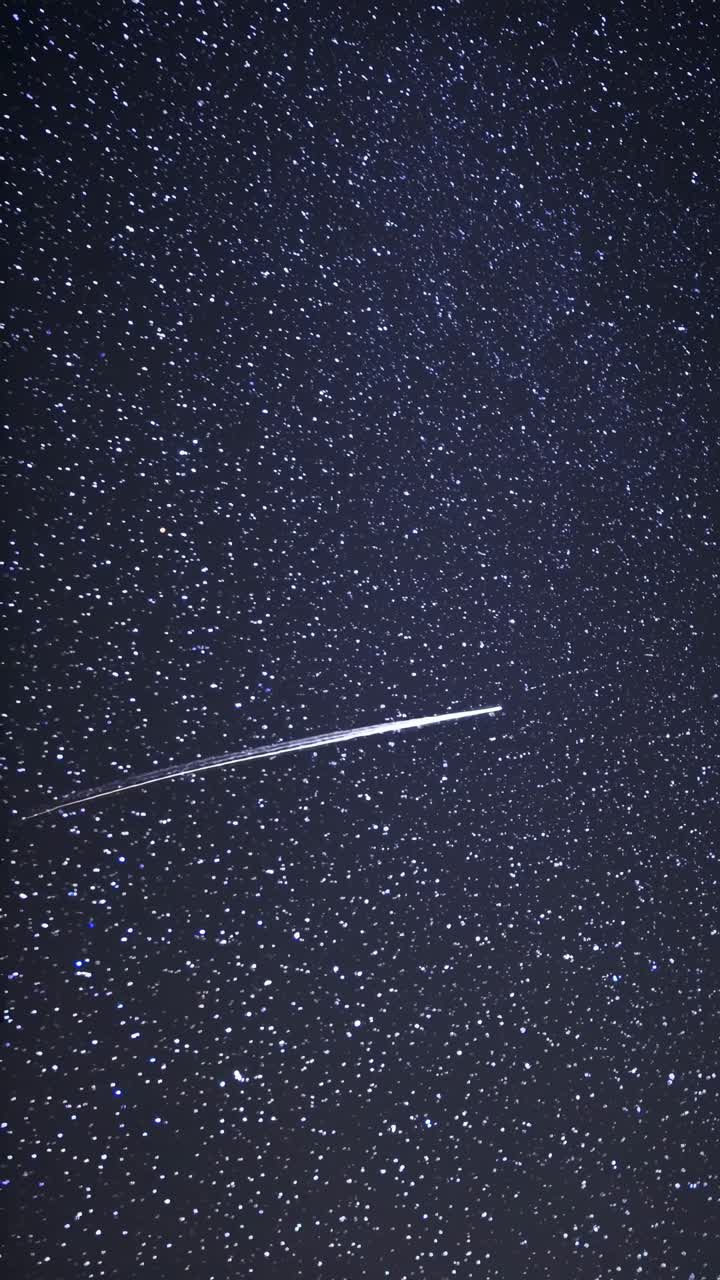 A mesmerizing night sky filled with stars and a shooting star streaking across