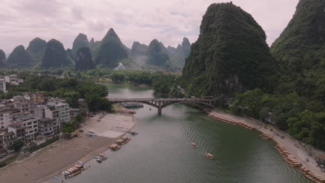 aerial view rotating toward the yangshuo bridge on the li river, summer in china