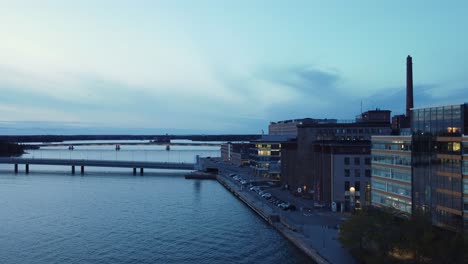 helsinki blue hour aerial rises over salmisaari region harbor bridges