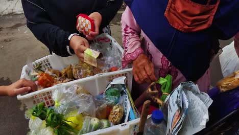 A-person's-hand-handing-money-to-another-person-to-make-a-payment