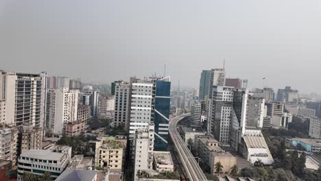 elevated metro train track winding through a dense urban cityscape