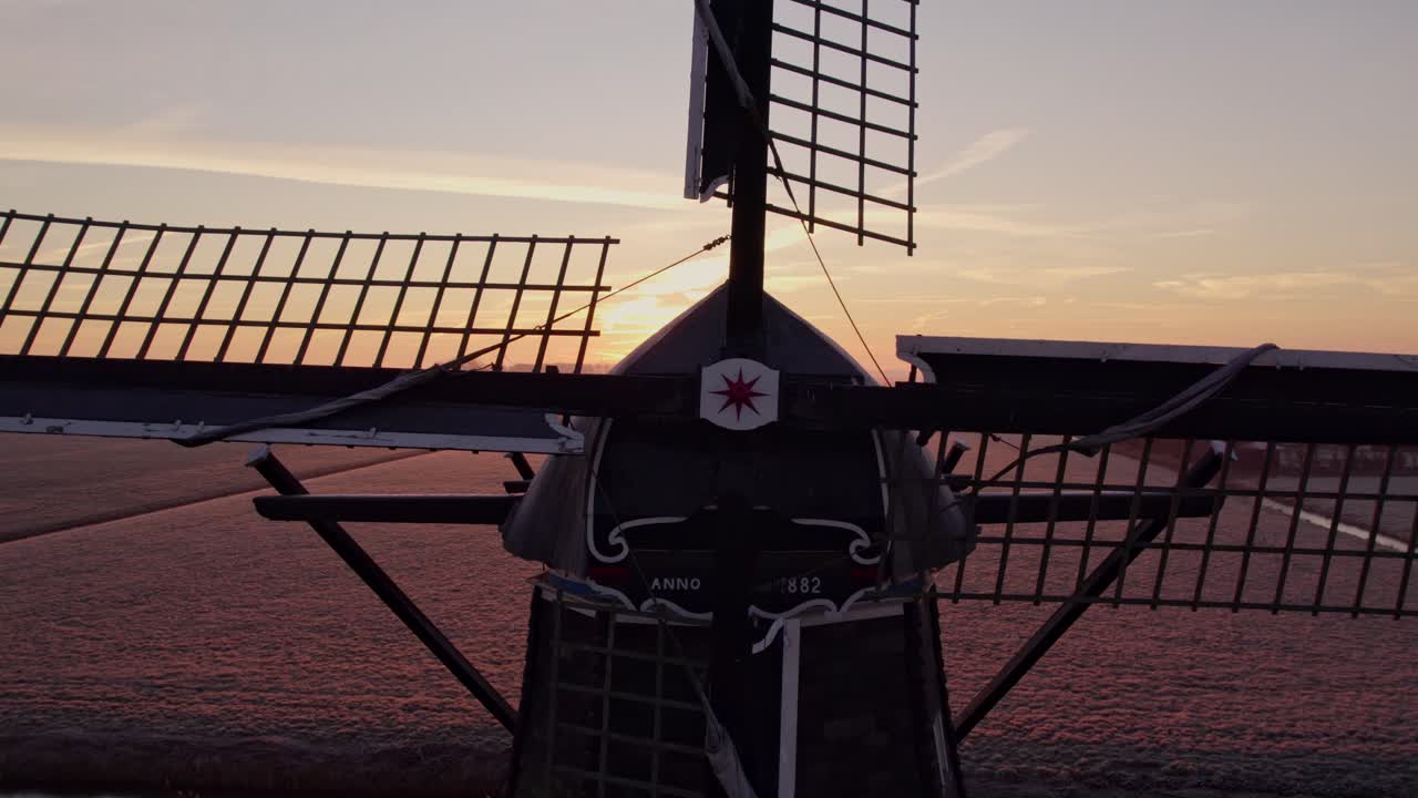 Tjerkwerd’s Babuurster Molen windmill at dawn, vibrant meadow glow