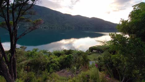 the sunrise over endeavour inlet in the south island of new zealand as seen from the queen charlotte track