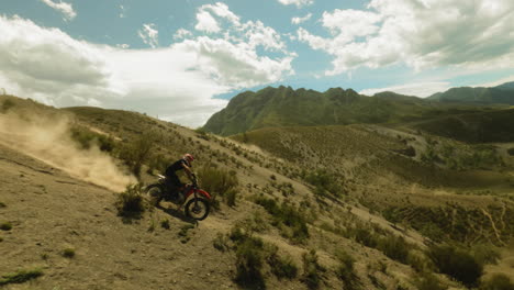 biker rides motorcycle downhill fpv drone. brave motorcyclist drives vehicle competing for championship in highland racing. freedom of speed and motion