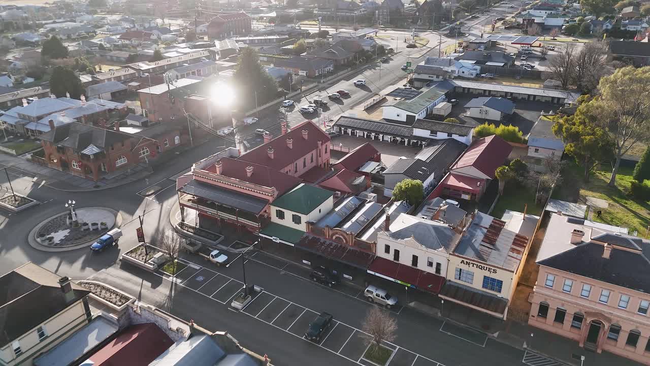 Drone footage glides above Glen Innes, New South Wales, revealing historic commercial buildings, quiet streets, and morning sunlight with smooth camera movement
