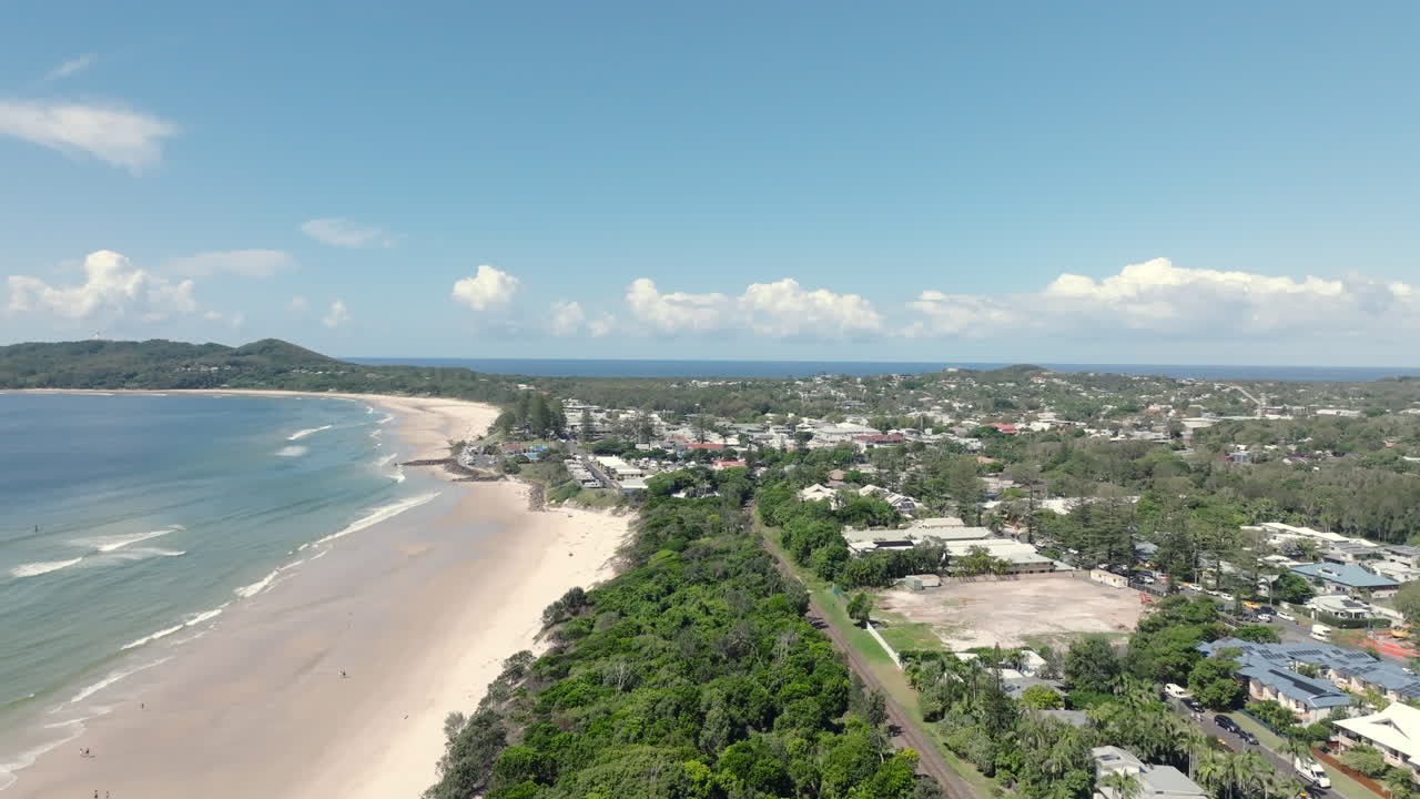 Drone footage of Byron Bay in New South Wales, Australia, showing the coastal town, sandy beach, and ocean