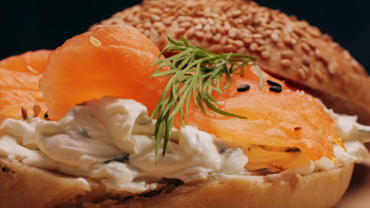 Bagel sandwich brunch, lunch plate of a bagel with smoked salmon and cream cheese and ham, close up morning cafe menu.