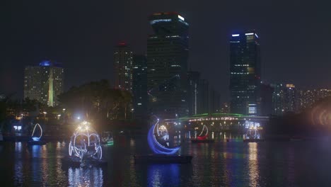 beautiful romantic night park view with river in the city town lights and boats