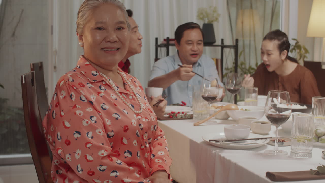 Portrait of Senior Woman Celebrating with Family during Dinner
