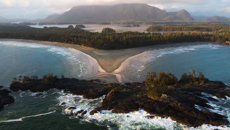 Tilt-up-aerial-view-of-Chesterman-beach-in-Tofino,-British-Columbia,-Canada