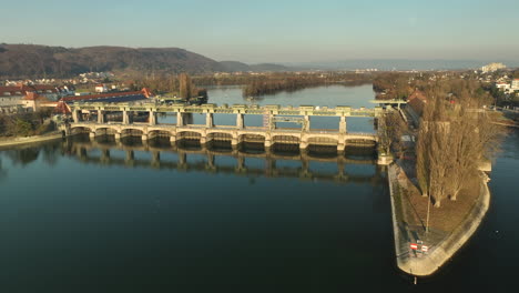 beautiful reflection of the hydro power plant of augst on the calm upper rhine on the german and swiss border