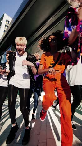 energetic dancers are joyfully exiting a modern glass building, sunlight illuminating their dynamic movement and casting long shadows on the pavement
