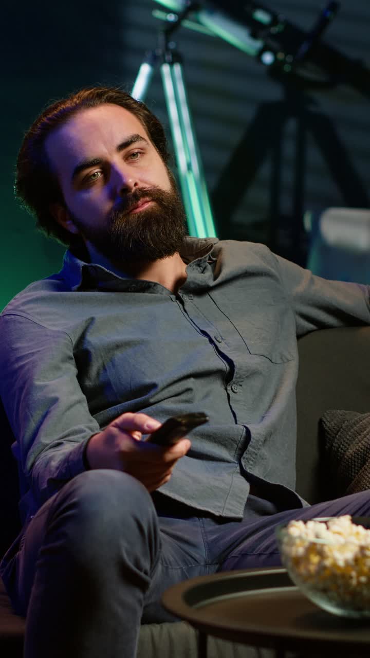 Vertical video Bored person scrolling through TV channel, frustrated by uninteresting content