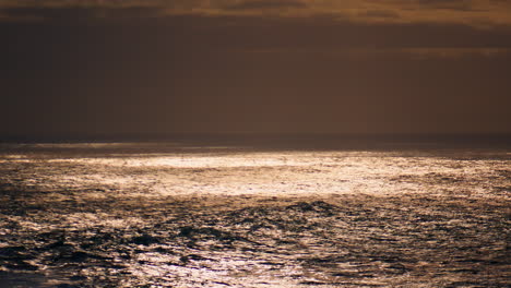 ocean surface reflecting sunlight at cloudy sky. peaceful endless sea landscape.