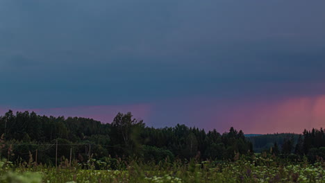 Time-lapse-of-many-Thunderbolts-flashing-at-dark-sky-during-thunderstorm-in-nature---Flying-dark-clouds-outdoors-near-forest---wide-shot