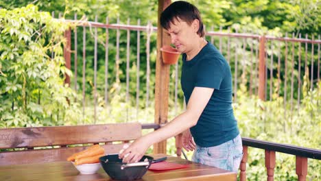 Der-Typ-Kocht-Pilaw,-Ist-Im-Sommerhaus-Und-Bereitet-Sich-Auf-Ein-Picknick-Vor,-Zeigt-Seine-Arbeit