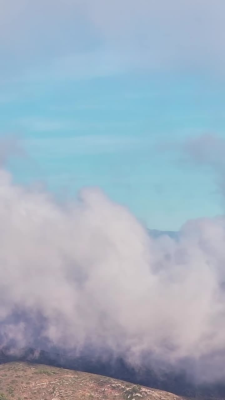 Clouds covering hills in Malaga Spain during a sunny day