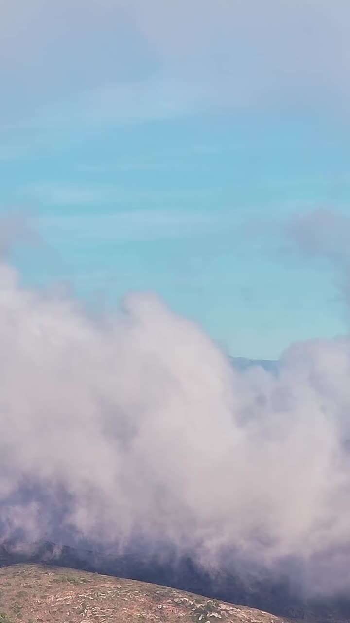 Clouds covering hills in Malaga Spain during a sunny day