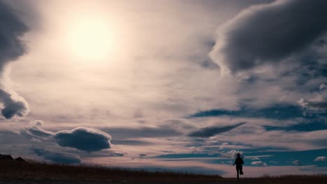 striking black silhouette outline of a female jogger, jogging against a dramatic sky