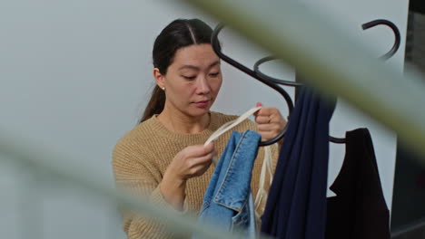 woman returning from shopping hanging up coat on stand before carrying bag into home 2