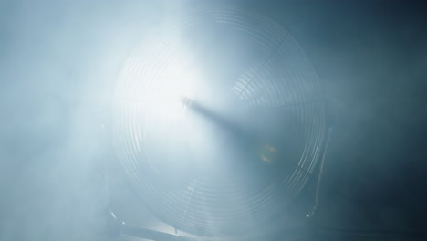 fan blades rotate in clouds of smoke