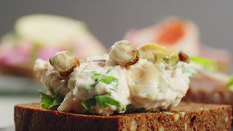 close-up of a salmon and mussel sandwich