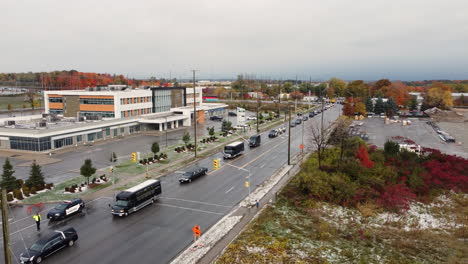 convoy of vehicles on the street at the funeral procession of slain policemen in barrie, ontario, canada