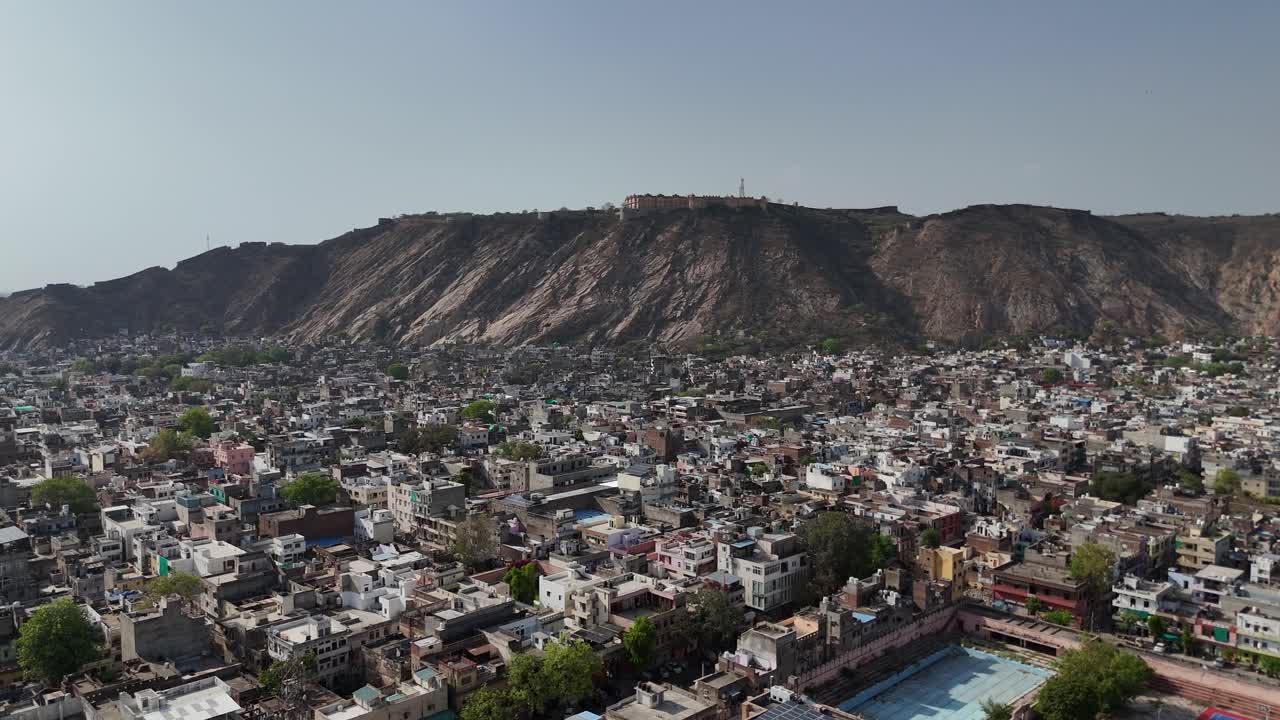 Aerial perspective of the fortified hilltop and dense urban core below.