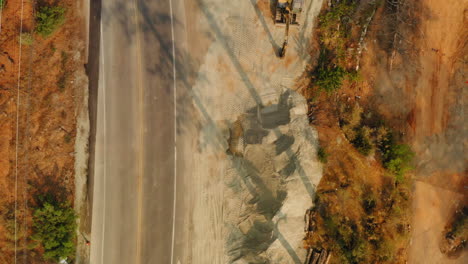 Above-view-of-an-excavator-working-on-a-material-sand-quarry-pile