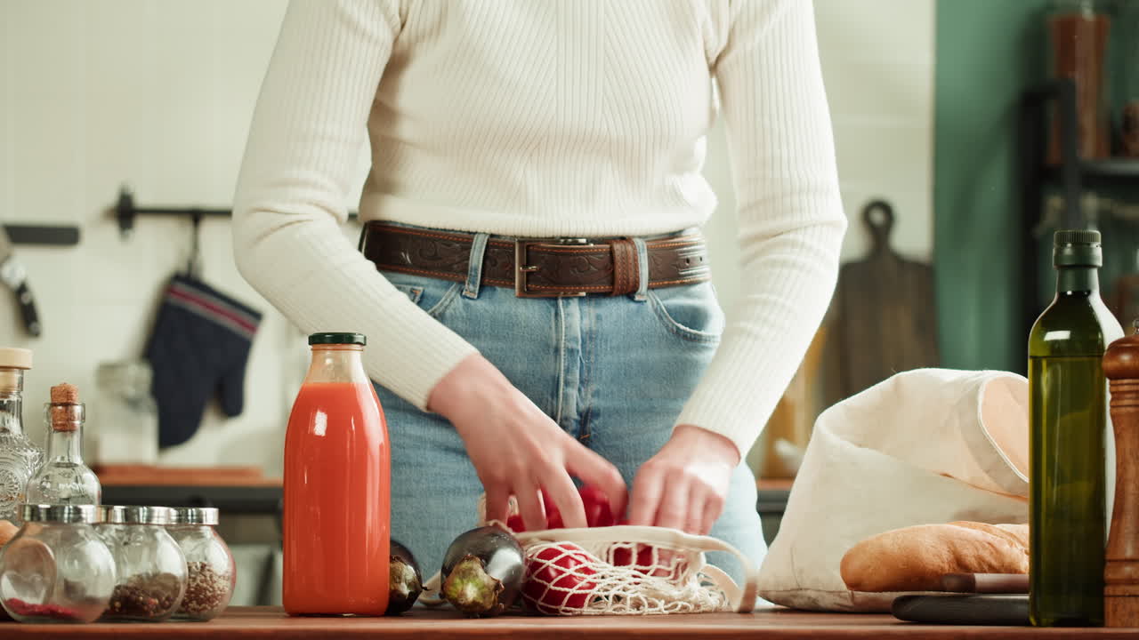 Woman grocery shopping putting groceries on kitchen table
