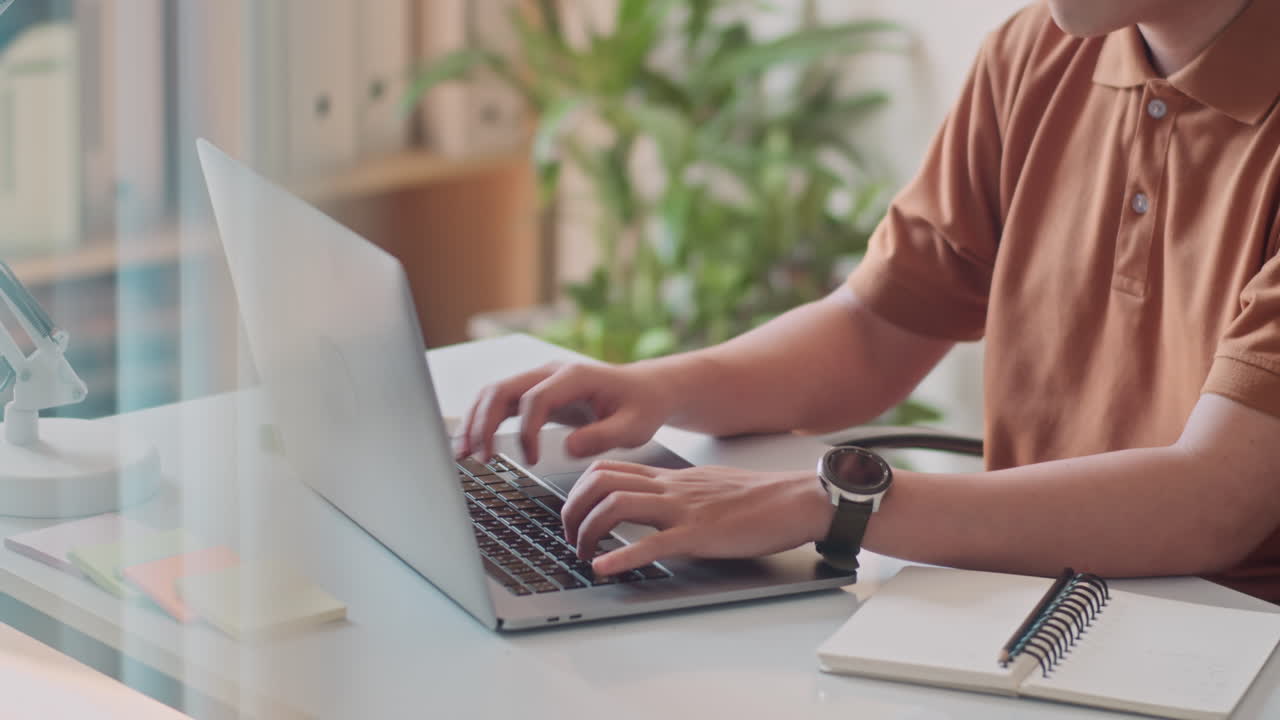 Businessman Typing Email on Laptop at Office Desk