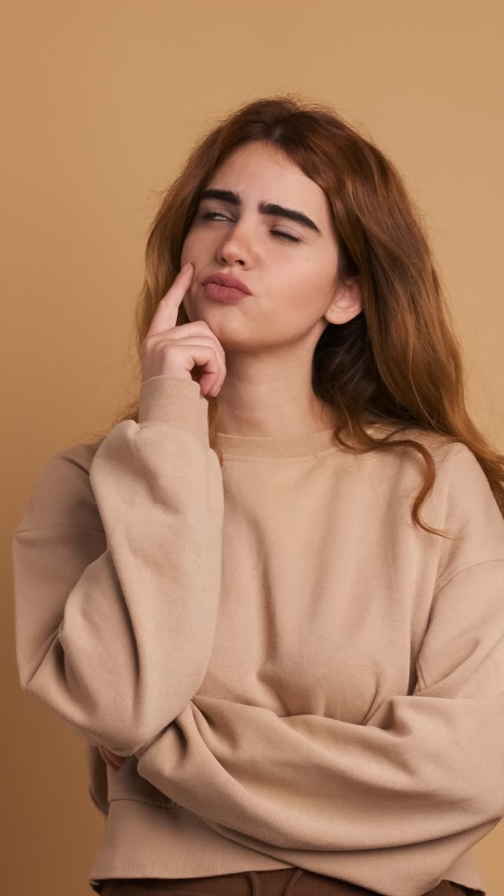 Woman with hand of face and thoughtful expression. Vertical Footage