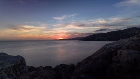 a stunning timelapse capturing the serene beauty of the mediterranean sunset, with vibrant sky colors reflecting over calm ocean waters. perfect for tranquil and scenic themes.