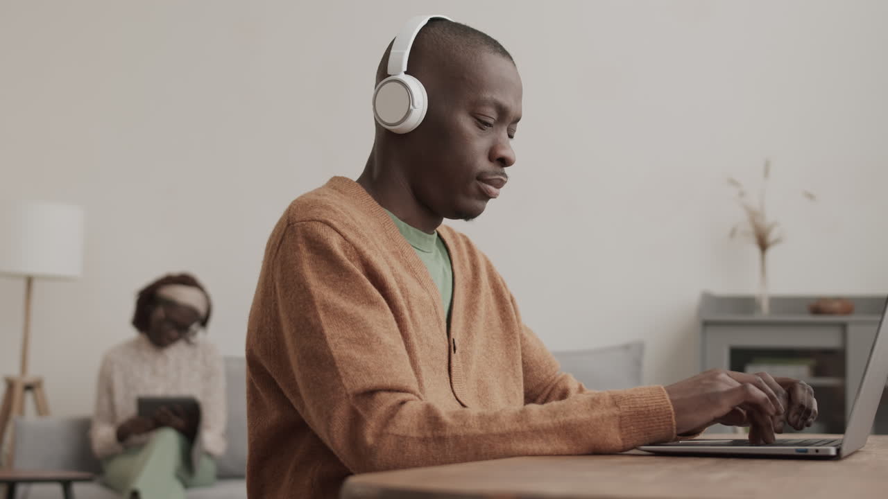 African Businessman Working on Laptop at Home