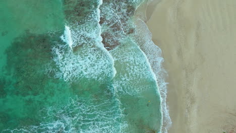 vertical view of turquoise beach with crashing waves in cyprus, middle east