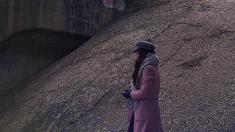 woman walking near a tunnel with graffiti