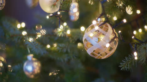 gold bauble on a beautifully decorated christmas tree close-up