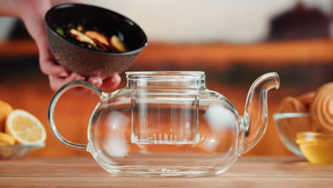 preparing loose leaf tea in a glass teapot