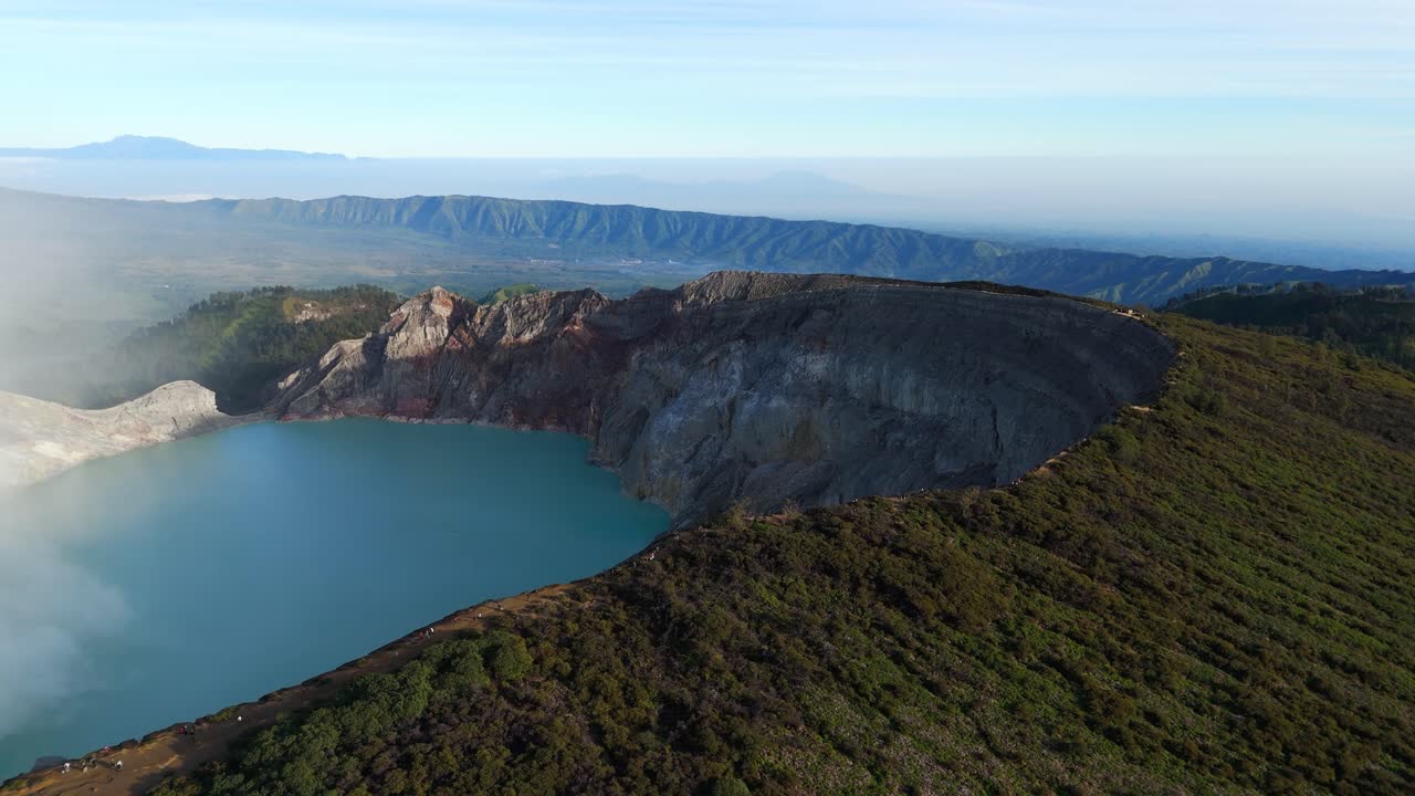 Spectacular drone shot of crater lake of Kawah Ijen Volcano at Sunrise in East Java, Indonesia. Aerial wide shot