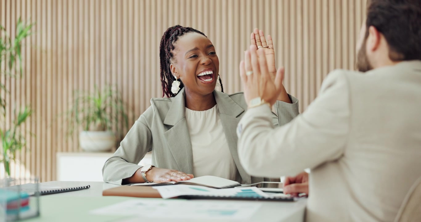 Business Colleagues Celebrating Success with a High Five in Office