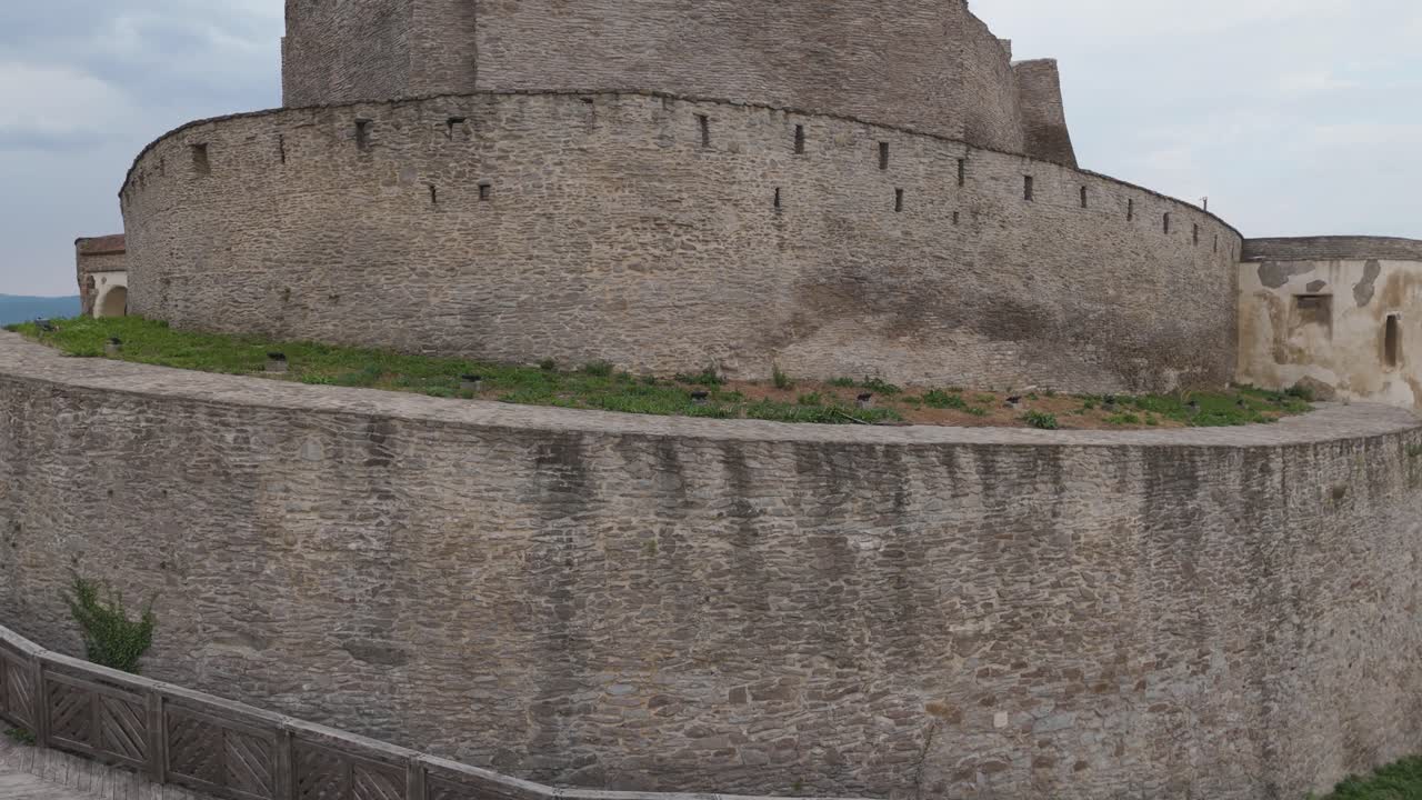 Drone circling and ascending over the medieval Fortress of Deva, offering panoramic views of the ancient stronghold