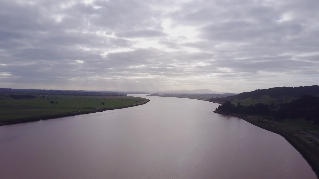Aerial drone flying upwards over the Wairoa River near Dargaville in Northland, New Zealand